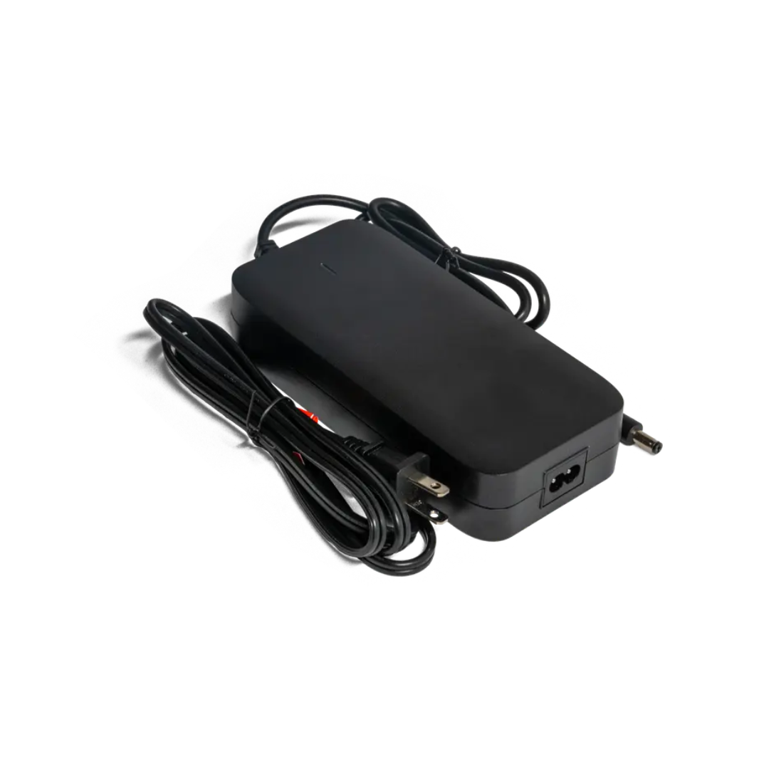 A black Dashmoto Accessories For Dash 3 Scooter power adapter with cords on both ends—one with a standard plug, the other a cylindrical connector—shown on a white background.